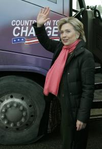 Democratic presidential candidate Hillary Clinton waves by her campaign bus outside a polling place.