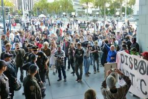 Demonstrators gather outside a BART station to demand that the transit police be disbanded