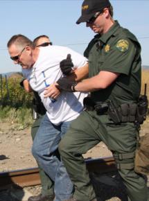 An ILWU member arrested during a protest that blocked a train carrying grain to a scab terminal