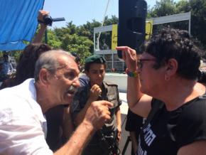 Israeli Black Panther Reuven Abergil (left) confronts a right-wing Israeli disruptor at a rally for African asylum seekers
