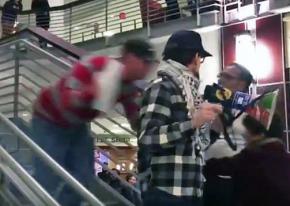 An Ohio State University student (blurry figure at left) pushed rally speaker Tim Adams down a flight of stairs in the Ohio Union